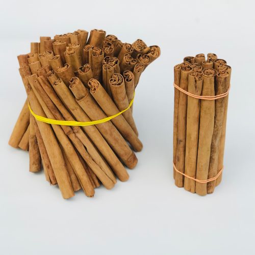Close-up of thin, multi-layered, delicate Ceylon Cinnamon sticks (quills), showing their distinct paper-like texture and light brown color.