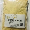 Hand stirring a spoonful of ginger powder into a warm mug of herbal tea or a healthy smoothie.