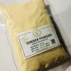 Close-up of finely ground, light yellow ginger powder, showing its consistent texture and fresh appearance.