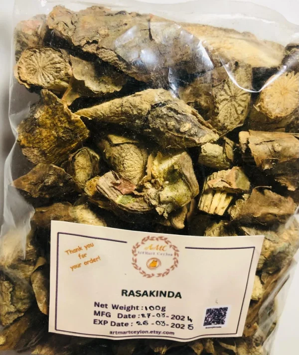 Dried Rasakinda Root pieces simmering in water in a traditional clay pot or a glass, preparing a herbal decoction.