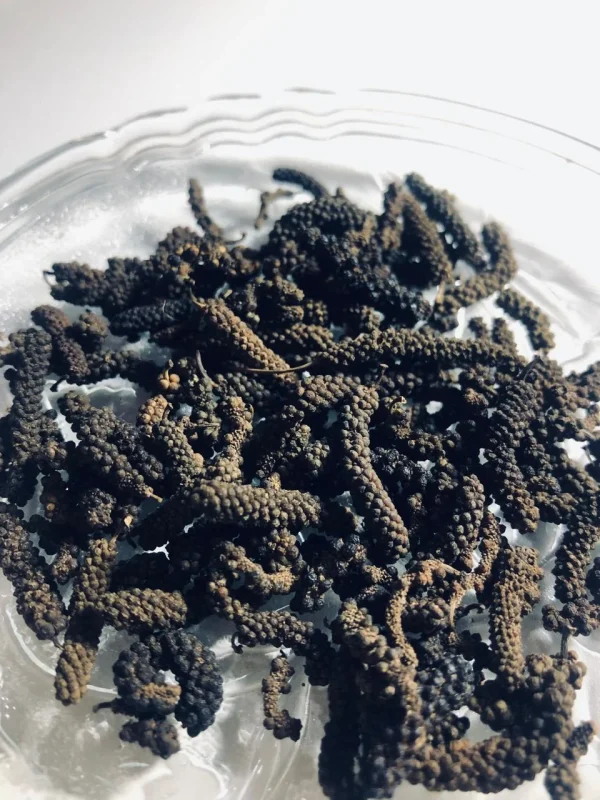 Branded, clearly labeled bag of 100% pure Thippili (Long Pepper / Piper longum), indicating organic sourcing.