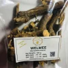 Dried Walmee (Licorice) root pieces steeping in hot water in a glass or traditional teapot, creating a light, sweet herbal infusion.