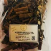 Dried whole Neeramulliya herb steeping in hot water in a glass or traditional clay pot for a herbal decoction.