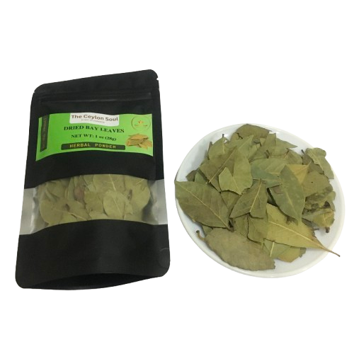 A pile of whole, dried bay leaves on a rustic wooden surface, highlighting their natural and aromatic quality for cooking.