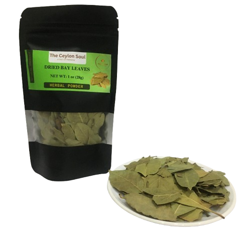 A pile of whole, dried bay leaves on a rustic wooden surface, highlighting their natural and aromatic quality for cooking.