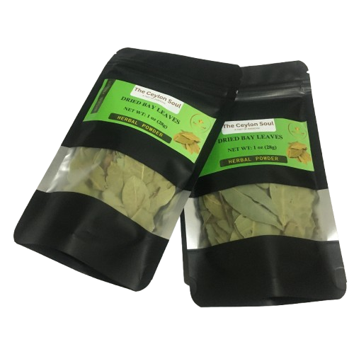 A pile of whole, dried bay leaves on a rustic wooden surface, highlighting their natural and aromatic quality for cooking.